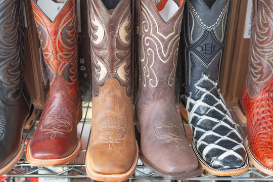 Mexico, Texas United State. Multicolor leather cowboy boots neatly displayed a store shelf.