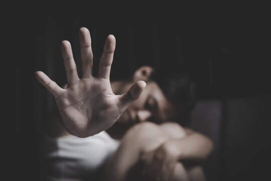 Open palm gesture with woman in background