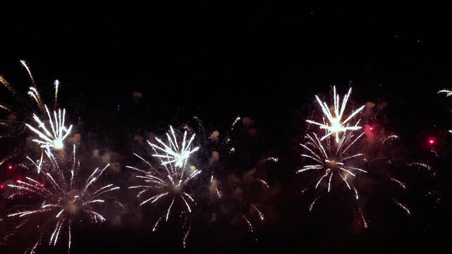 Bright colorful fireworks exploding in night sky festive celebration.