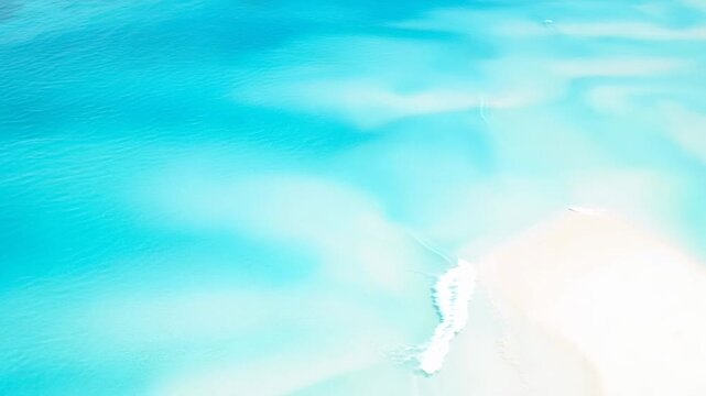 Calm Turquoise Water with Gentle Waves Reflecting Sunlight Creating a Serene Atmosphere