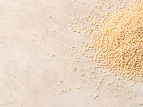 Sesame seeds on neutral stone culinary texture
