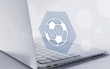 Computadora portátil moderna con aplicación interactiva de fútbol en pantalla que simboliza deporte digital, apuestas y pasión, en un entorno tecnológico limpio y brillante. © sh99