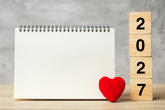 2027 cubes with red heart shape and empty notebook on table for your text. New Year, Resolution, Goal, plan, health, Love and Happy Valentine day concept