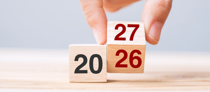 hand flip cube block 2026 to 2027 text on table. Resolution, review, strategy, end year, goal, business and New Year holiday concepts