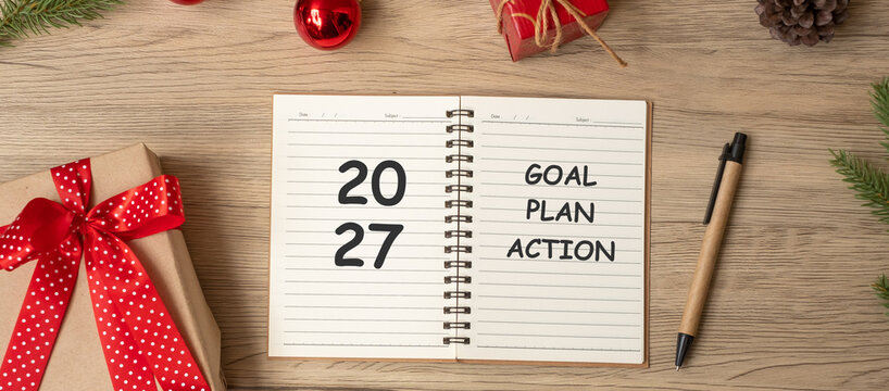 2027 Goal Plan Action with notebook, Christmas gift and pen on wood table. Xmas, Happy New Year, Resolution, To do list, start and Strategy concept