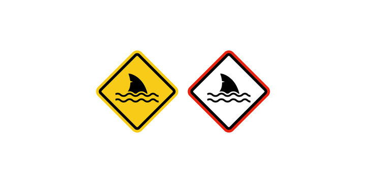Yellow and red diamond warning signs with shark fin in water, indicating shark presence or danger.