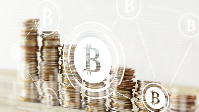 Bitcoin coins stacked on a surface with digital icons and symbols around them