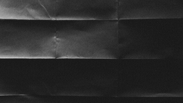 Crumpled black cardboard with wrinkles and wrinkled folds. Old wrapping dusty paper