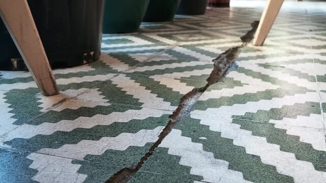 Crack develops in tile flooring during building inspection