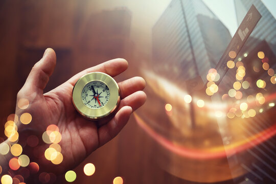 Double exposure businessman with vintage compass in a hand and skyscraper.  concept to make decision or choose direction