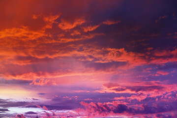 Fototapeta premium Beautiful sunset sky above clouds with dramatic light. Cabin view from airplane