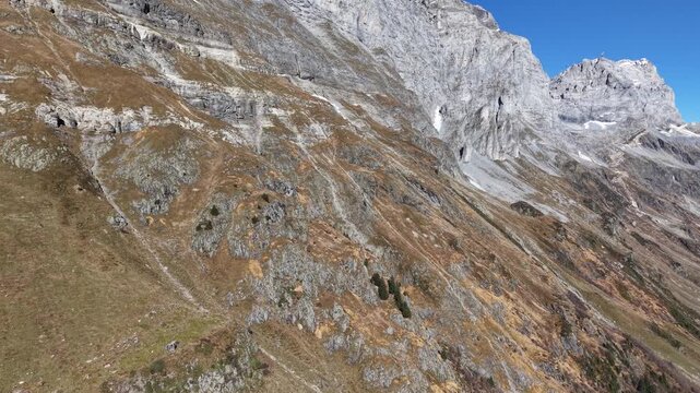 drone shot of a massive rockface at sustenpass, switzerland on a sunny day.