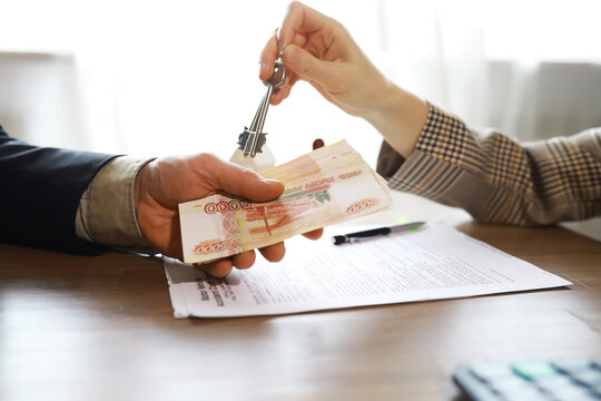 Businessman giving money, Russian Ruble currency, to hs partner - payment, loan and bribery concept