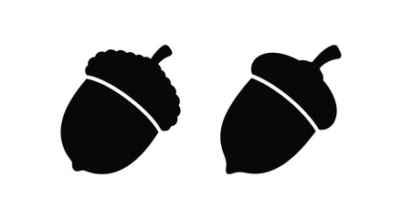 Two black silhouettes of acorns display a simple natural form against a white background acorn © rasi999