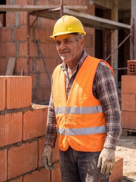 professional worker using masonry trowel and cement mortar during construction
