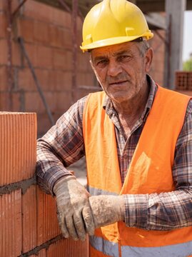 professional worker using masonry trowel and cement mortar during construction