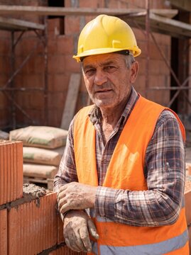 professional worker using masonry trowel and cement mortar during construction