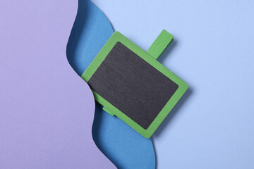 Chalkboard clips on wavy paper cut-out layer background. Minimalism. Conceptual photo. Creative layout © splitov27