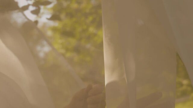 Softness. A woman&rsquo;s hand glides over the fabric, symbolizing lightness and freedom.
