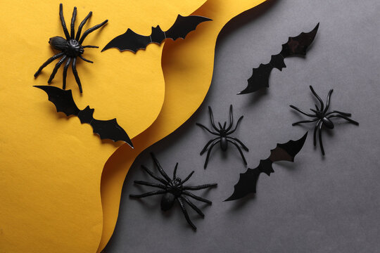 Toy spiders and bats on a wavy layered background. Halloween concept. Trick or treat. Creative layout