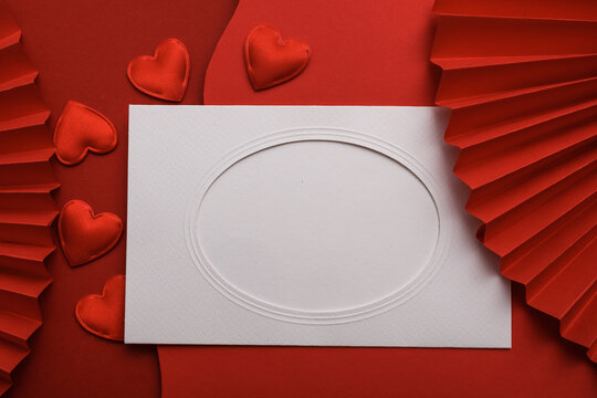 Blank card and Hearts on a red background with traditional Chinese paper fans. Festive background. Love concept