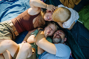 Obraz premium Happy family spending time together during summer camping trip.