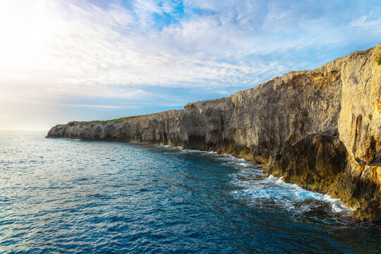 panorama of rocky cliff coast along sea water surface clear weather silent morning scenery