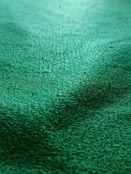 Close-up view of a green textured surface.  The fabric has a rough nap.