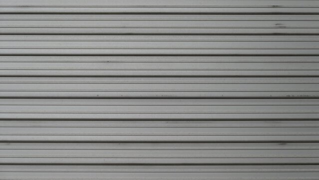 Aged Metal Shutter with Horizontal Lines and Gray Texture