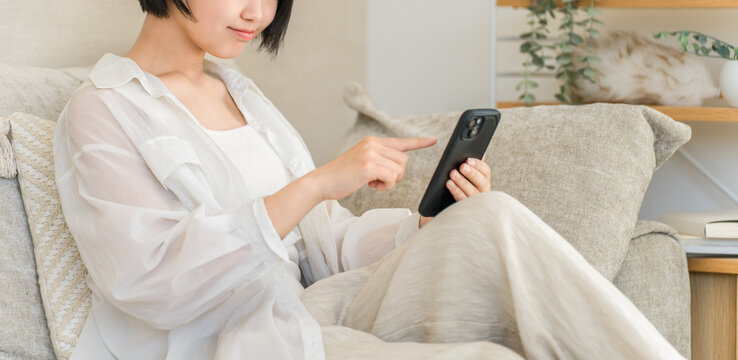 Teenage High School Girl Using a Smartphone at Home, Browsing Social Media Posts and Online Reviews