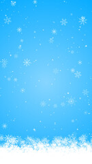 Fototapeta premium snow flakes bottom border frame falling on blue ,winter snow flakes new year and Christmas holiday copy space vertical social media background