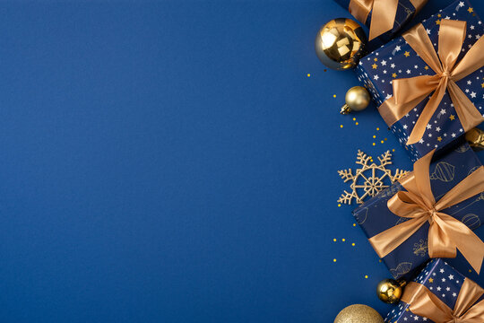 Blue and gold Christmas presents with satin bows and ornaments for Merry Christmas and Happy New Year on dark blue mockup