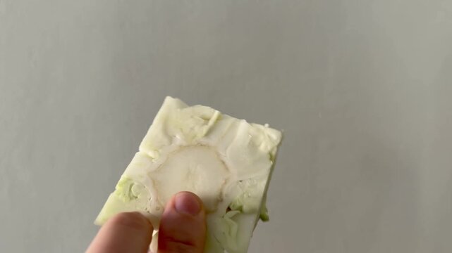 Hand Holding the Cut Core of a Fresh Cabbage