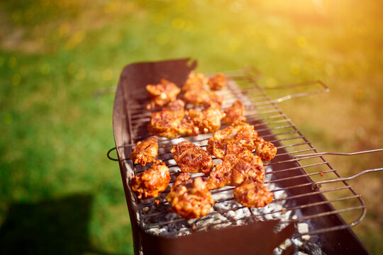 Spicy chicken wings grilled over glowing coals