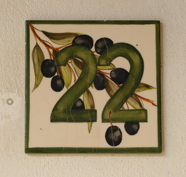 House number plate 22 close-up, Seborga, Italy