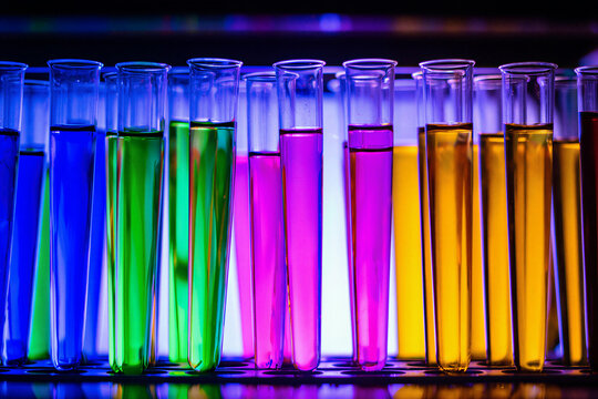 Rows of colourful test tubes glowing with backlight