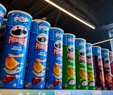 containers of pringles on a shelf in a store