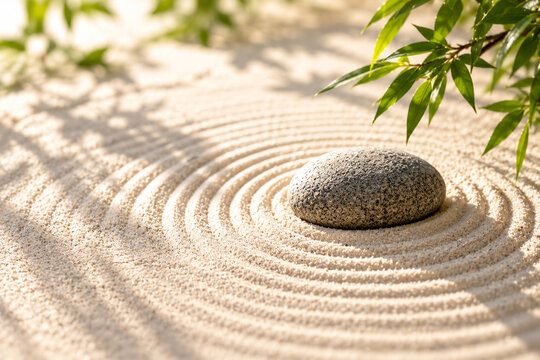 Minimal Japanese zen garden with stone and raked sand copy space