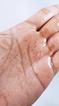 Clear gel with raspberry extract on palm skin. Refreshing skincare texture, hydrating and antioxidant formula for glowing skin.