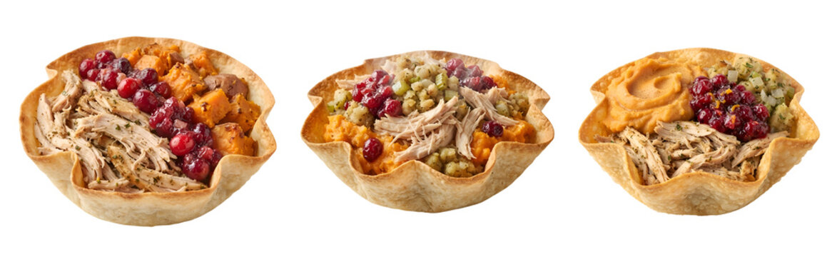 Festive thanksgiving turkey bowls featuring roasted sweet potatoes stuffing shredded poultry and fresh tart cranberries served in crispy flour tortilla shells presented on transparent background