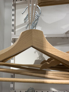 Wooden hangers inside an empty wardrobe