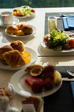 A Vibrant Breakfast Spread Featuring Fresh Fruits, Croissants, Salads, and Refreshing Beverages Perfect for a Leisurely Morning