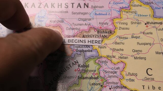 Travel Begins Here paper label placed on map of Central Asia