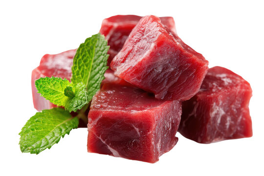 Fresh beef cubes rest atop a white background. Fresh beef cubes rest atop a white background. Mint leaves add a touch of green contrast