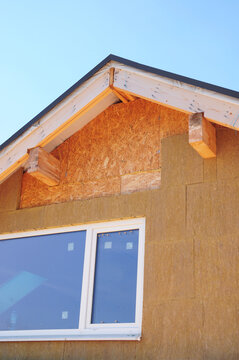 Attic house rooftop insulation installation with mineral wool outdoors