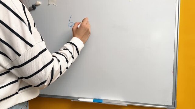 Writing a Business Plan Heading on a Whiteboard with a Blue Marker