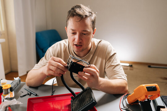 Portrait of skilled technician male repairing and installing computer liquid cooling system, showcasing pc building, technical support. Concept of computer hardware maintenance and upgrade.