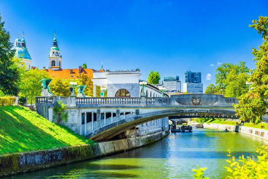 Dragon bridge over Ljubljanica river and skyline of Ljubljana, capital of Slovenia, popular tourist destination 