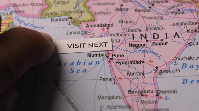 Paper with Visit Next text placed on map of India for travel planning concept