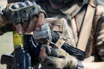 Fototapeta premium Ukrainian soldier handling tactical weapon and ammunition outdoors